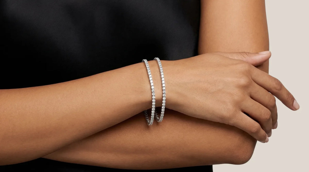 Tennisarmbånd med diamanter som viser forskjell i caratstørrelse og glans på håndledd