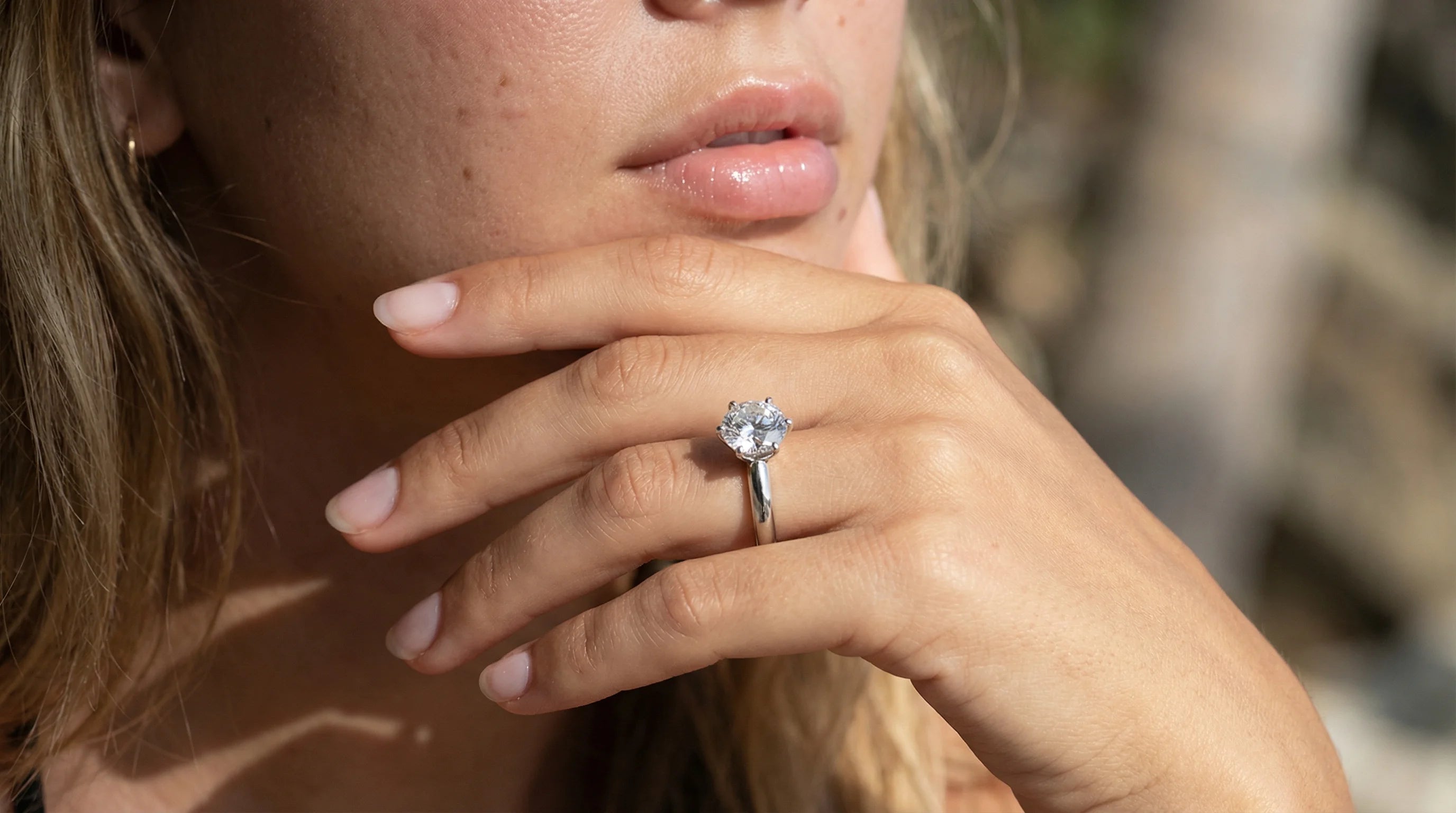 Forlovelsesring med rund lab-diamant i hvitt gull – nærbilde av hånd