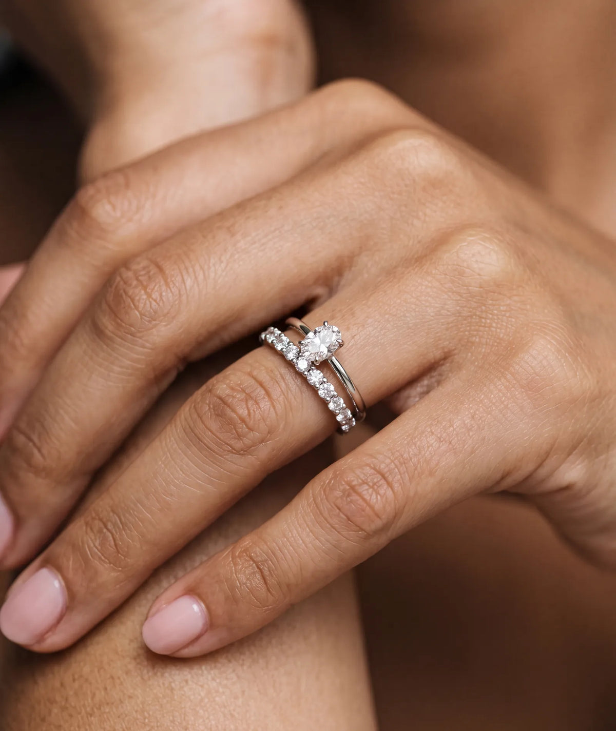Oval forlovelsesring i hvitt gull med 0,50 carat lab diamant vist på modell i naturlig lys