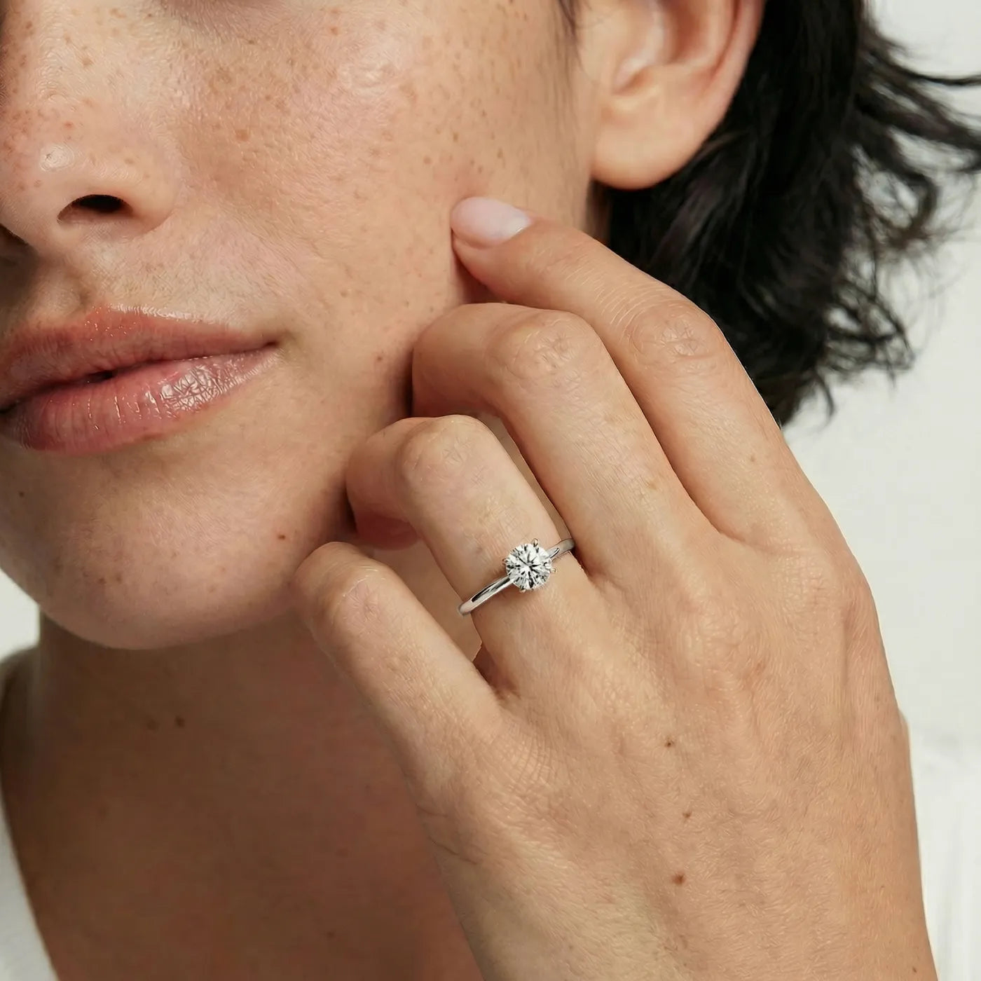 0,50 ct tynn diamantring i hvitt gull med lab diamant vist på modell i naturlig lys